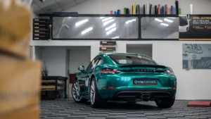 Porsche Cayman Wrapped in Avery Dennison Pearl Dark Green - Rear Photo Inside the Shop