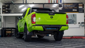 Nissan Navara wrapped in 3M's Gloss Light Green. Rear photo inside the shop.