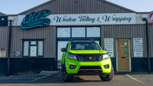 Nissan Navara wrapped in 3M's Gloss Light Green. Front photo outside of the shop.