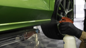 Ford Focus ST in for paint protection film application to the side skirts. Spraying the surface with the installation fluid.