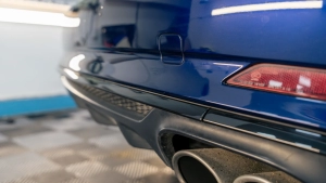 Audi S5 chrome delete. Progress photo of wrapping the rear bumper diffuser trim. Complete. Photo two.