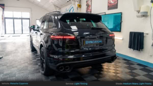 Porsche Cayenne Full Light Tinting - Medium Rears, Light Fronts. Rear 3/4 Photo with Lights On.