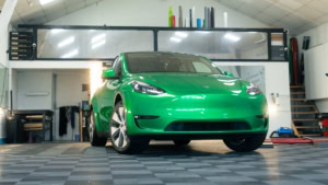 Tesla Model Y - Gloss Green Envy. Inside photo of the front of the car. Angle 3.