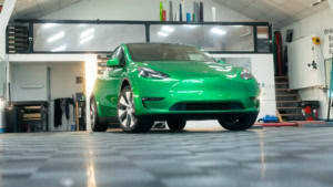 Tesla Model Y - Gloss Green Envy. Inside photo of the front of the car. Angle 1.