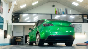 Tesla Model Y - Gloss Green Envy. Inside photo of the rear of the car. Angle 3.