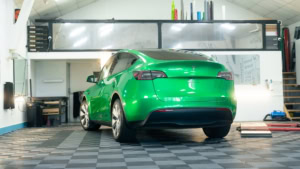 Tesla Model Y - Gloss Green Envy. Inside photo of the rear of the car. Angle 2.