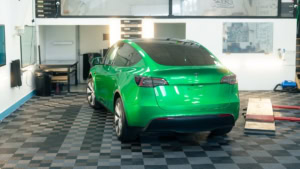 Tesla Model Y - Gloss Green Envy. Inside photo of the rear of the car. Angle 1.