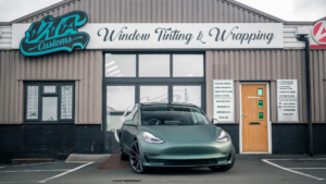 Tesla Model 3 - 3M Satin Pine Green Metallic. Front photo outside of the shop.
