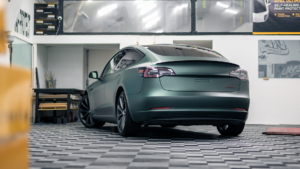 Tesla Model 3 - 3M Satin Pine Green Metallic. Rear photo inside the shop.