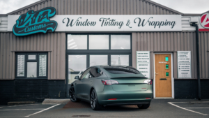 Tesla Model 3 - 3M Satin Pine Green Metallic. Rear photo outside of the shop.